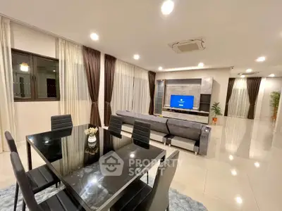 Spacious modern living room with elegant dining area and sleek furniture