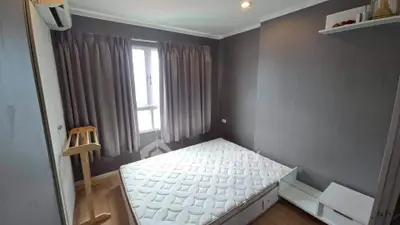 Cozy bedroom with natural light and modern decor, featuring a comfortable bed and stylish curtains.