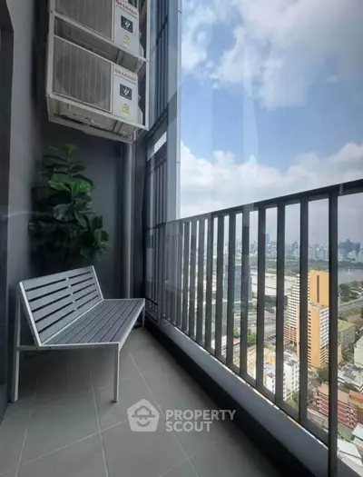 Modern balcony with city view, featuring sleek metal bench and air conditioning units, perfect for urban living.