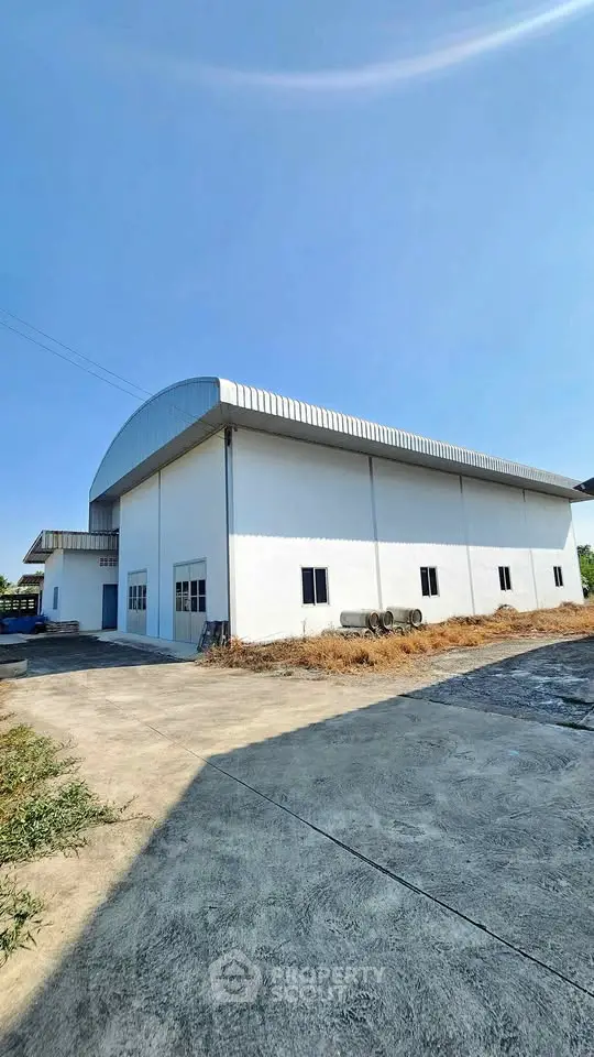 Spacious industrial warehouse with ample outdoor space and modern design.