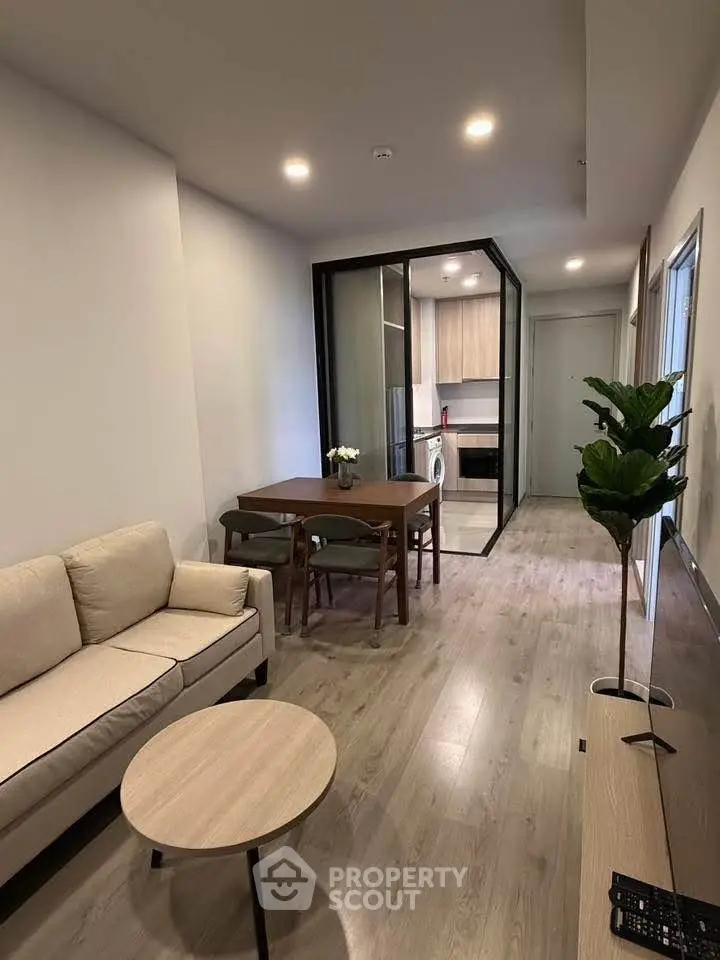 Modern living room with open kitchen and stylish furniture in a cozy apartment.