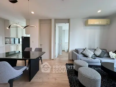 Modern living room with stylish furniture and open kitchen layout