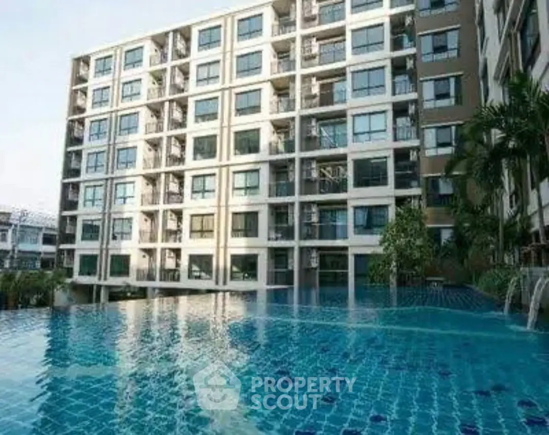 Luxurious apartment building with stunning pool view and modern architecture.