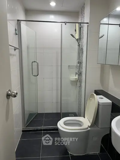 Modern bathroom with glass shower and sleek fixtures, perfect for a contemporary home.