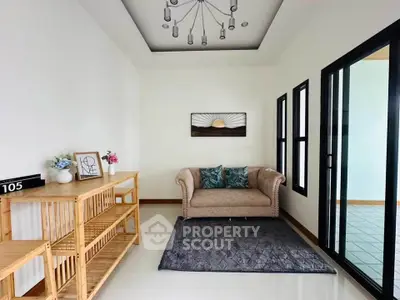 Chic modern living room with elegant sofa and stylish decor in a bright, airy space.