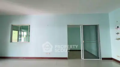 Spacious interior with sliding glass door and large window, ideal for modern living.