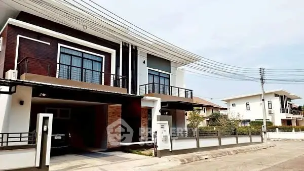 Modern two-story house with sleek design and spacious driveway in suburban neighborhood.