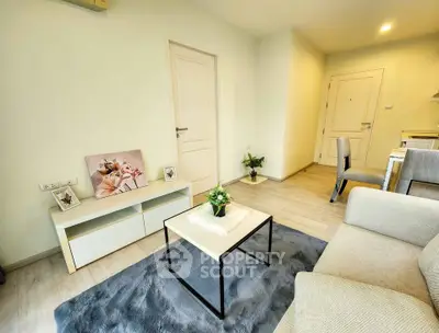 Modern living room with stylish decor and cozy ambiance, featuring a plush rug and elegant furniture.