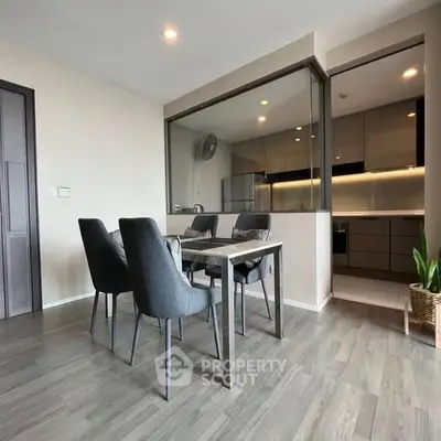 Modern dining area with sleek kitchen and elegant decor