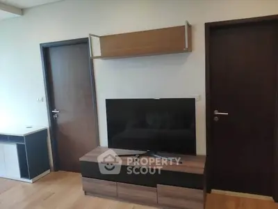 Modern living room with sleek TV stand and wall-mounted shelf, perfect for contemporary urban living.