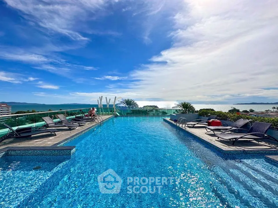 Stunning rooftop pool with panoramic ocean views and luxurious sun loungers.