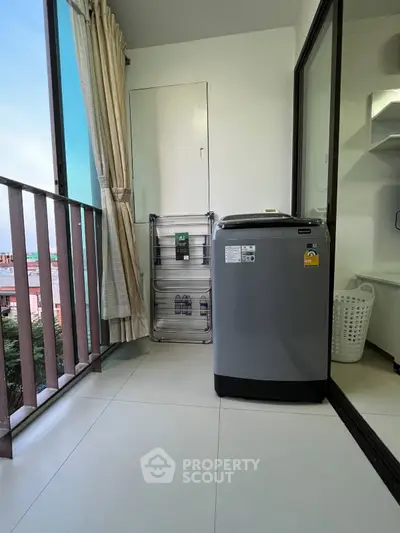 Modern balcony with washing machine and city view, perfect for urban living.