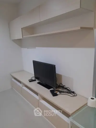 Modern living room with sleek TV unit and ample storage space