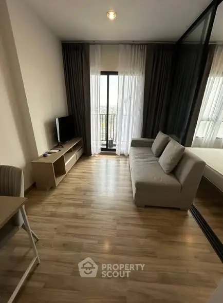Modern living room with wooden flooring and balcony view