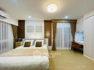 Spacious bedroom with elegant decor and natural light