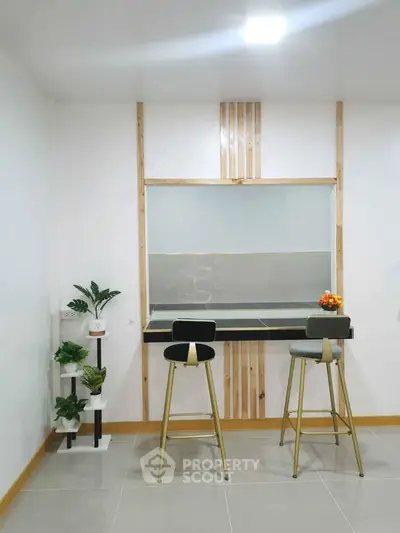 Modern minimalist kitchen with bar stools and decorative plants