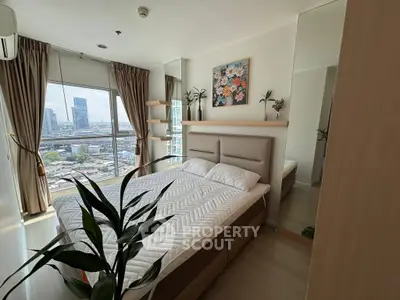 Modern bedroom with city view, featuring stylish decor and large windows for natural light.