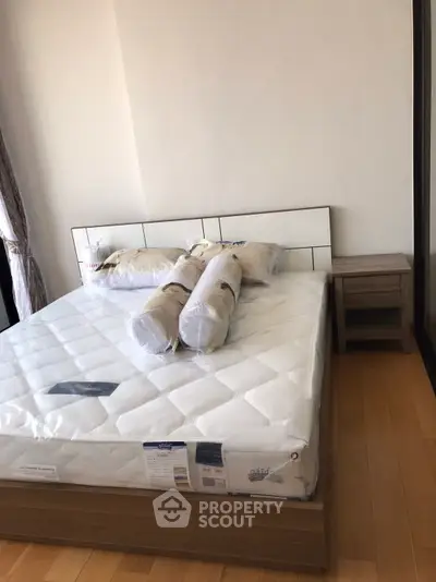 Modern bedroom with new mattress and stylish headboard in a bright apartment.