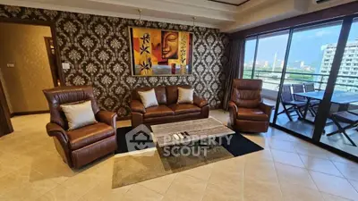 Luxurious living room with leather seating and stunning city view balcony.