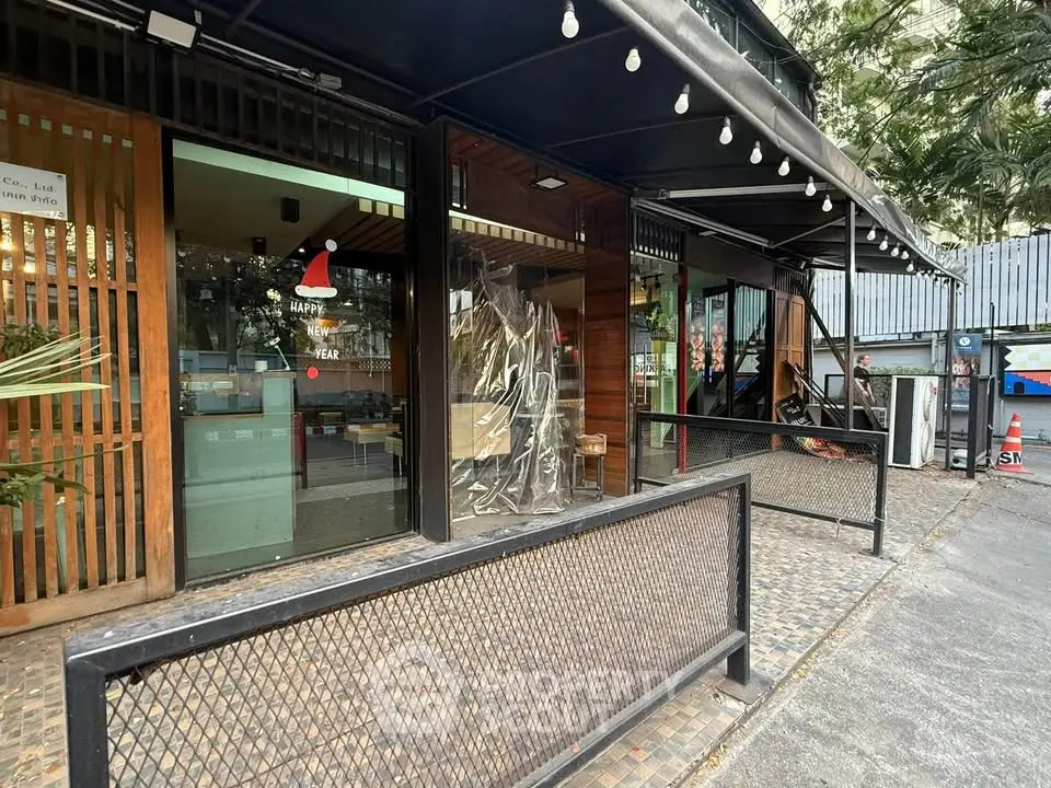 Charming commercial property with modern facade and outdoor seating area in bustling location.