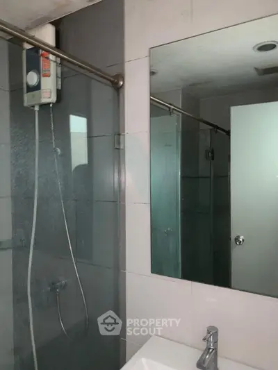 Modern bathroom with glass shower and sleek fixtures in a contemporary home.