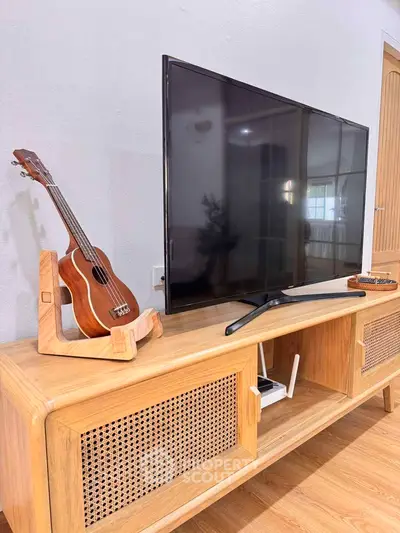 Stylish living room with modern TV stand and ukulele decor