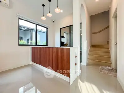 Modern interior with sleek staircase and stylish lighting in a contemporary home.