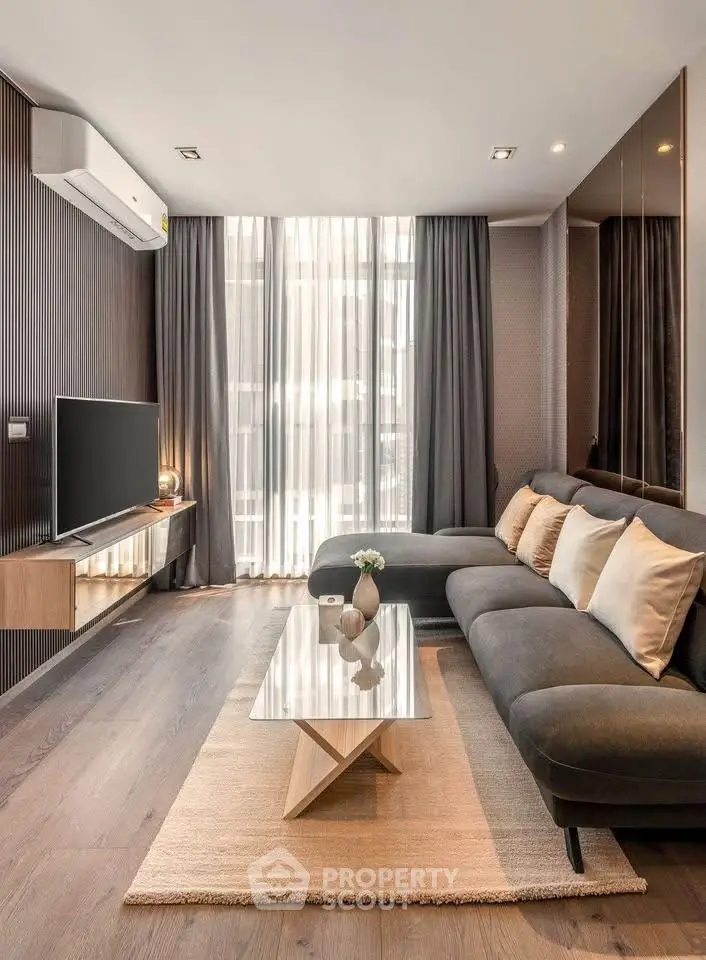 Modern living room with sleek design, featuring a cozy sectional sofa and stylish decor.