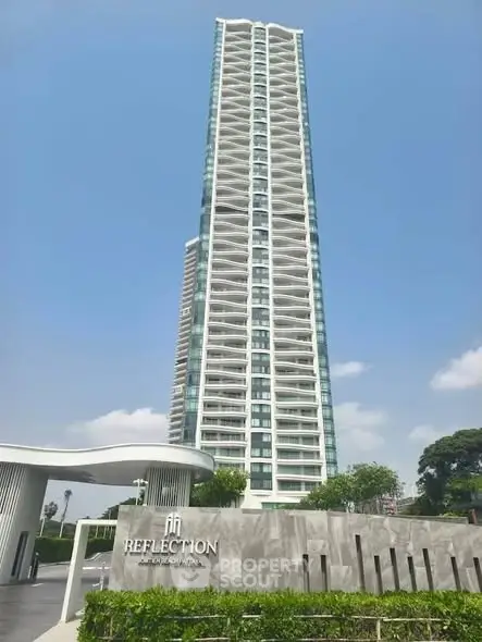 Stunning high-rise building with modern architecture and lush greenery at Reflection Pattaya.