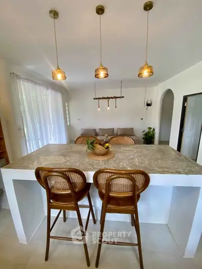 Chic open-plan kitchen with stylish island and cozy living area, perfect for modern living.