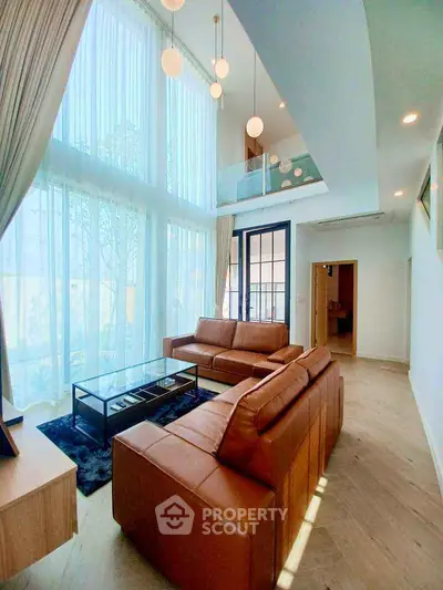 Luxurious living room with high ceilings and modern leather sofas