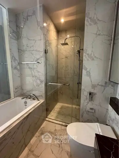 Luxurious marble bathroom with modern shower and bathtub