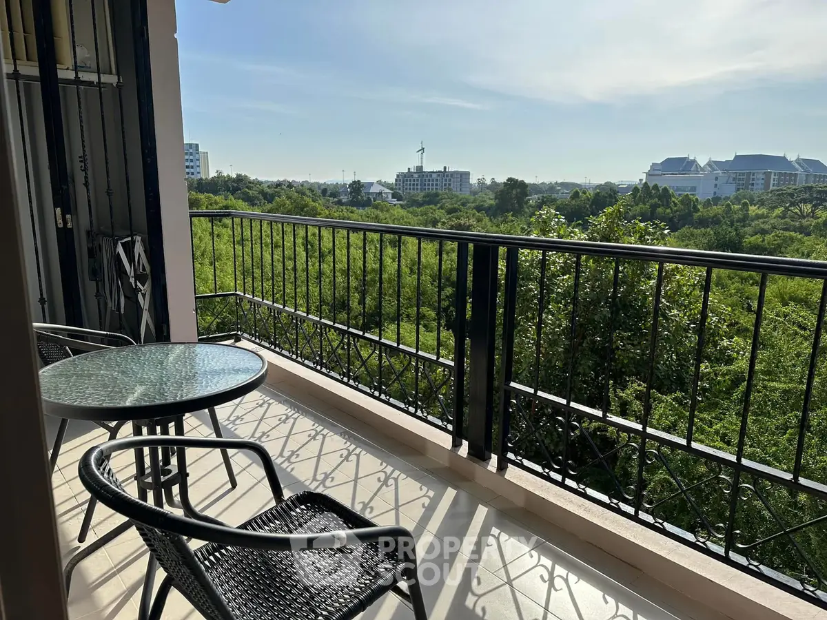 Spacious balcony with scenic green view and outdoor seating