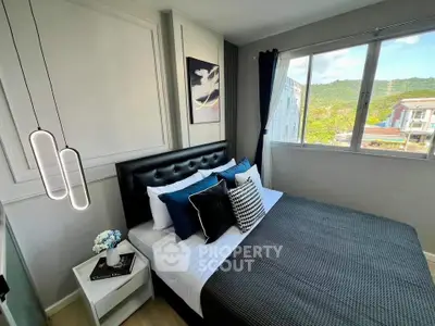 Modern bedroom with stylish decor and scenic window view