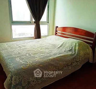 Cozy bedroom with large window and elegant wooden bed frame