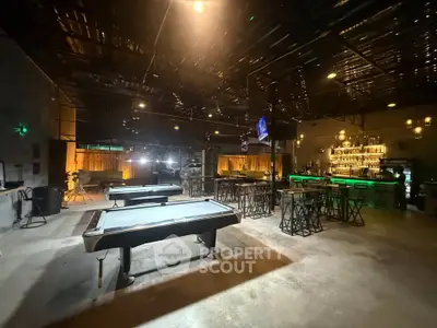 Spacious entertainment area with pool tables and bar, perfect for social gatherings.