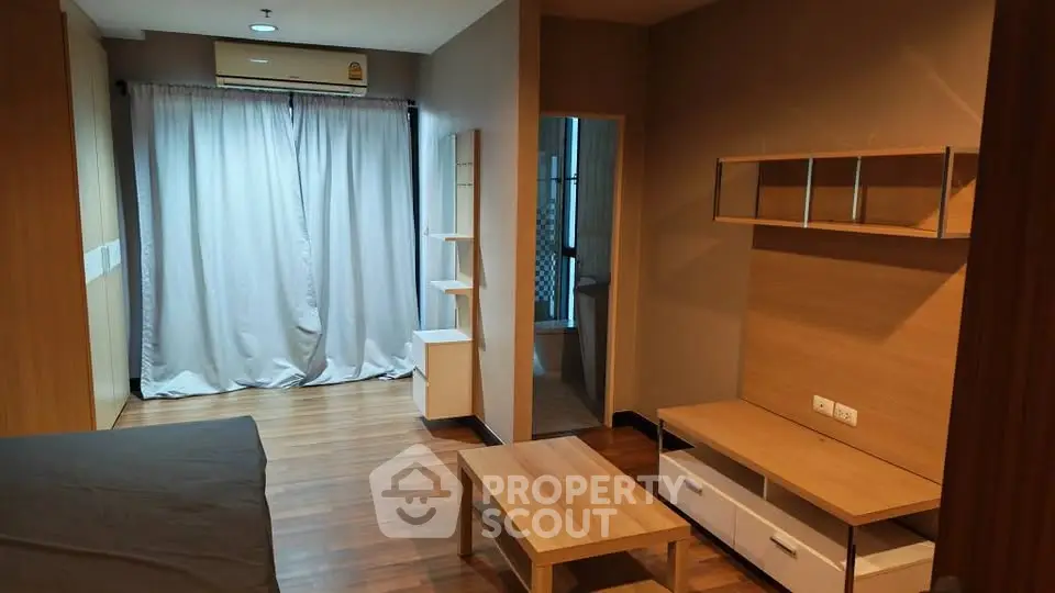 Modern studio apartment with wooden flooring and stylish furniture