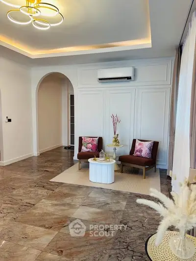 Elegant living room with marble flooring and stylish decor