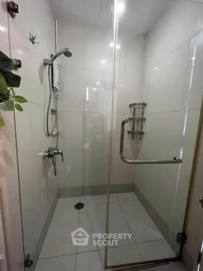 Modern bathroom with glass shower enclosure and sleek fixtures