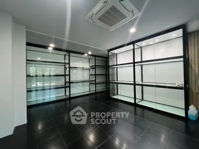 Spacious modern storage room with sleek black shelving and tiled floor