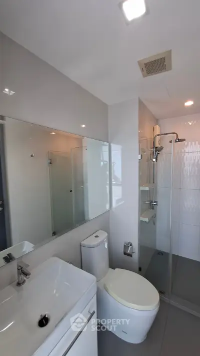 Modern bathroom with sleek fixtures and glass shower enclosure