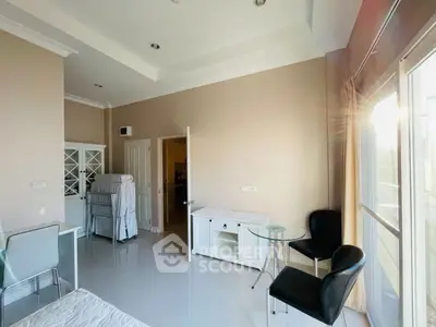 Bright and airy bedroom with modern furnishings and large windows for natural light.