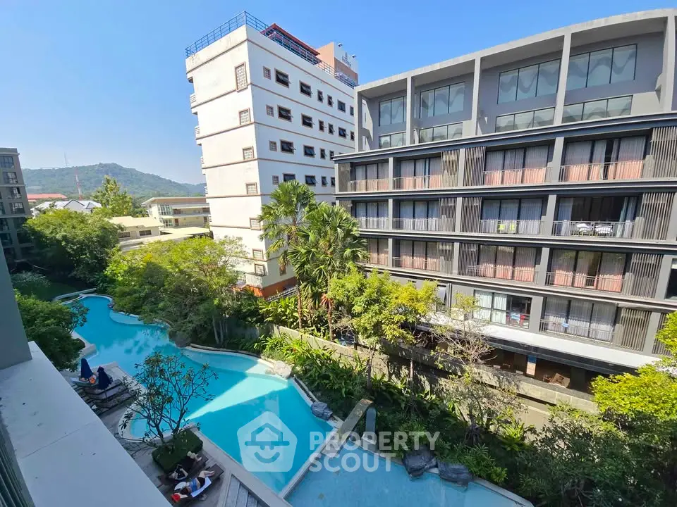 Luxurious apartment complex with stunning pool and lush greenery view