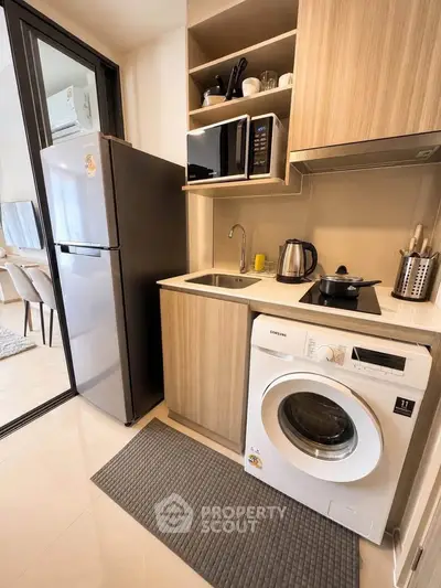Modern compact kitchen with washing machine and sleek appliances