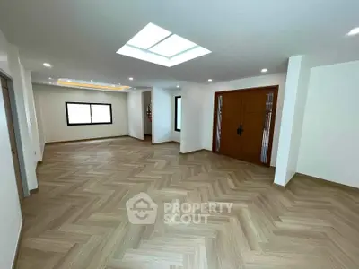 Spacious modern living room with skylight and elegant wooden flooring