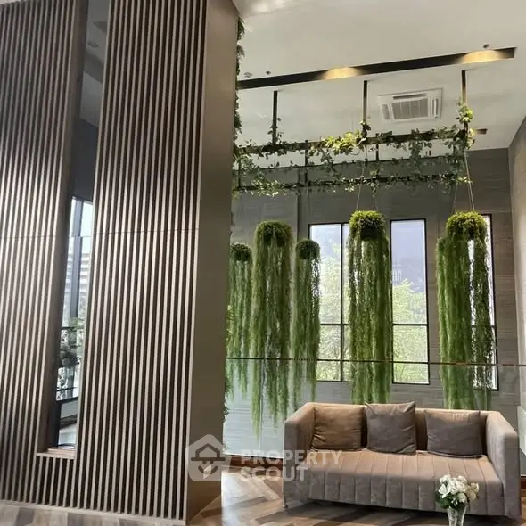 Modern living room with vertical garden and stylish sofa
