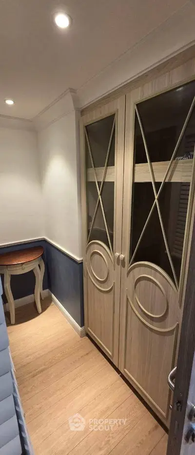 Elegant hallway with wooden flooring and stylish double doors