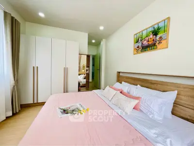 Cozy bedroom with modern decor and ample natural light
