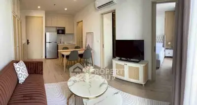 Modern living room with stylish furniture and open kitchen layout in a cozy apartment.