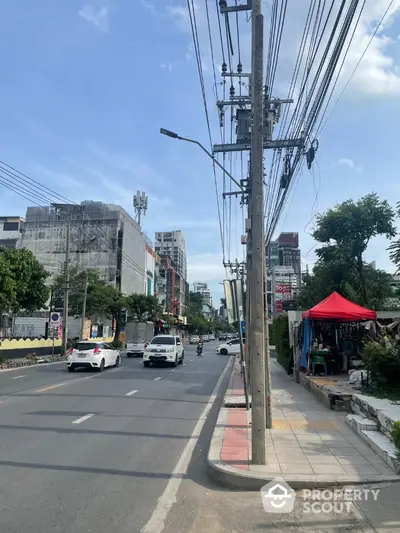 Urban street view with buildings and traffic, showcasing city life and infrastructure.